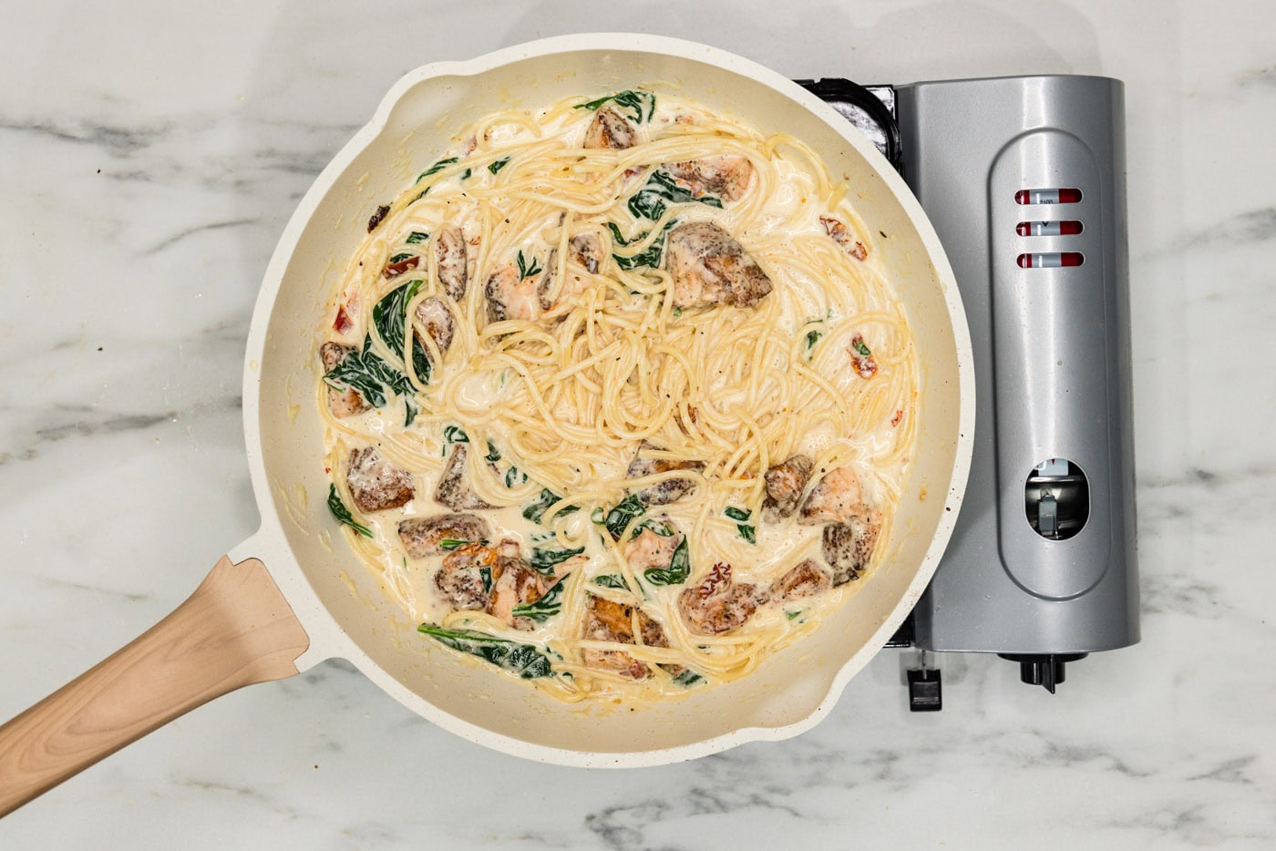 salmon pasta in a skillet with cream sauce