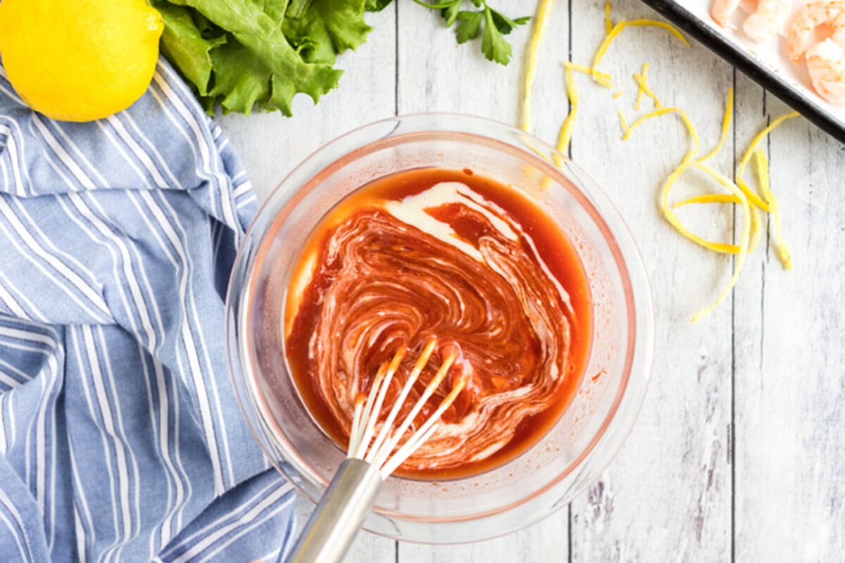 Whisking cocktail sauce ingredients in a bowl