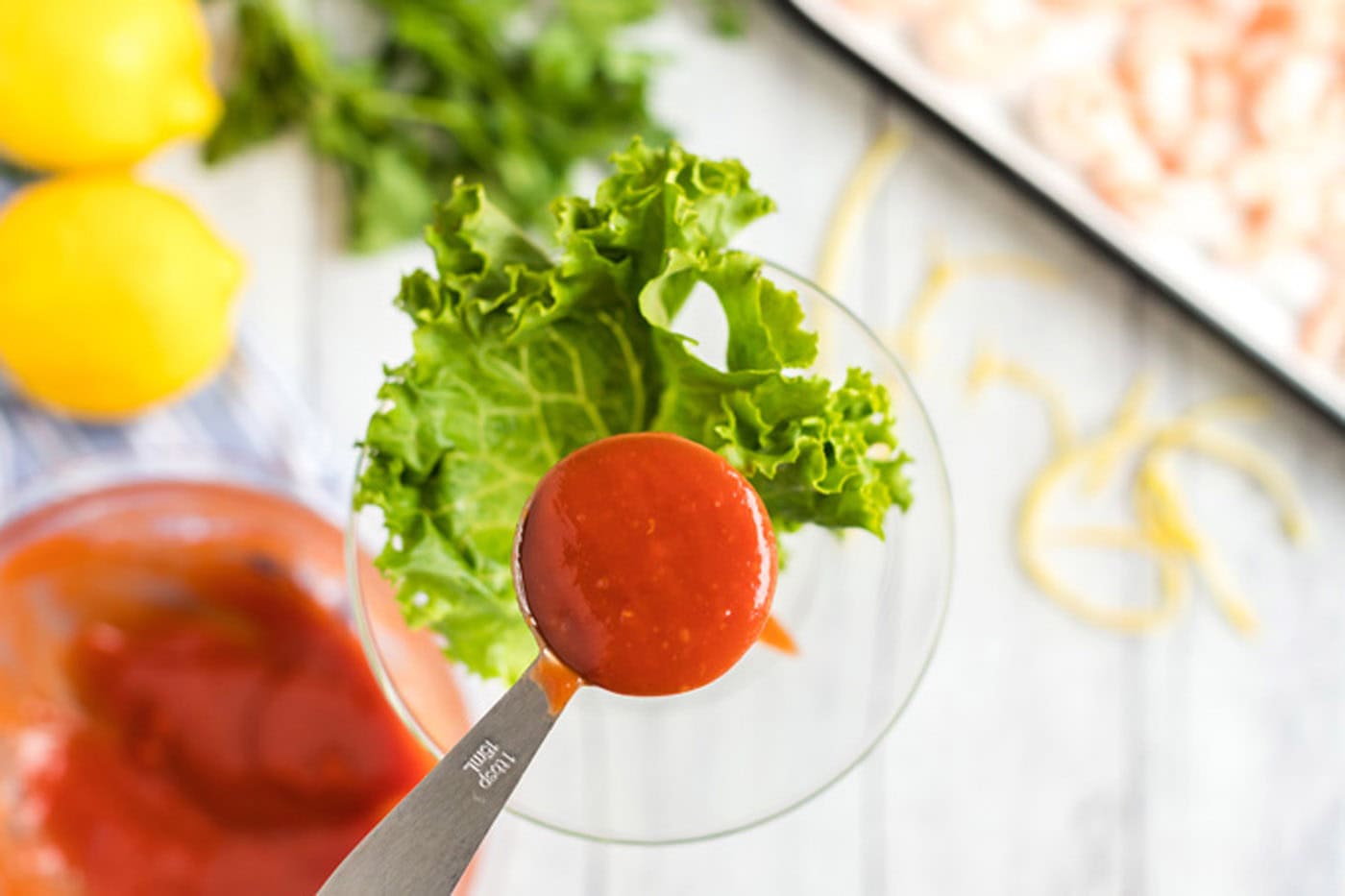 adding cocktail sauce to martini glass