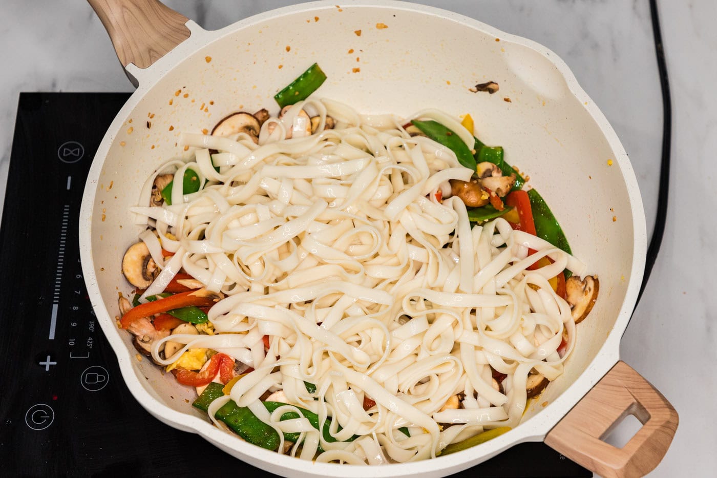 lo mein noodles added to skillet with stir fry veggies