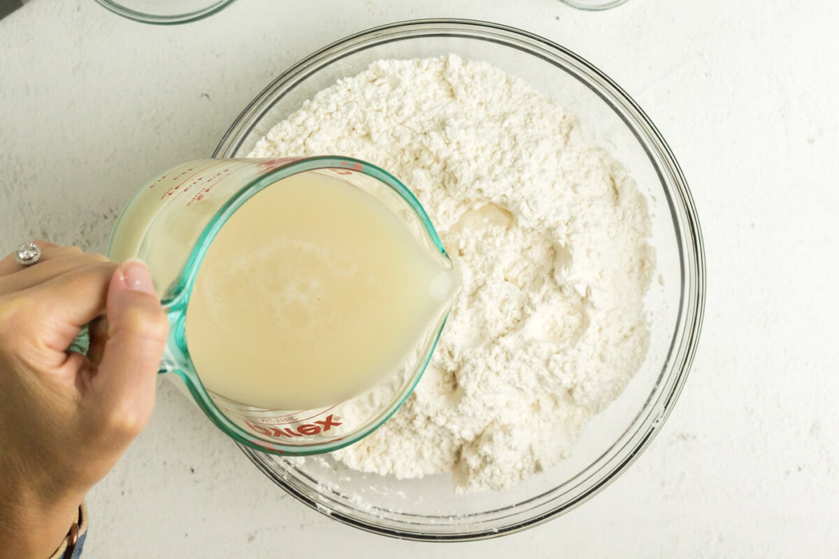 Yeast being poured into the flour mixture 