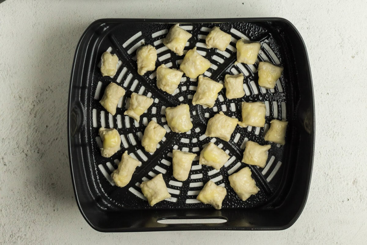 Pretzel dough bites in an air fryer basket 