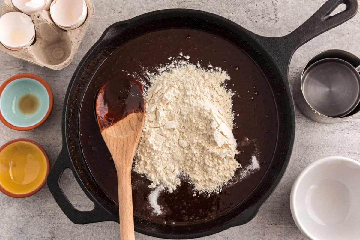 flour on top of chocolate brownie mixture in a skillet