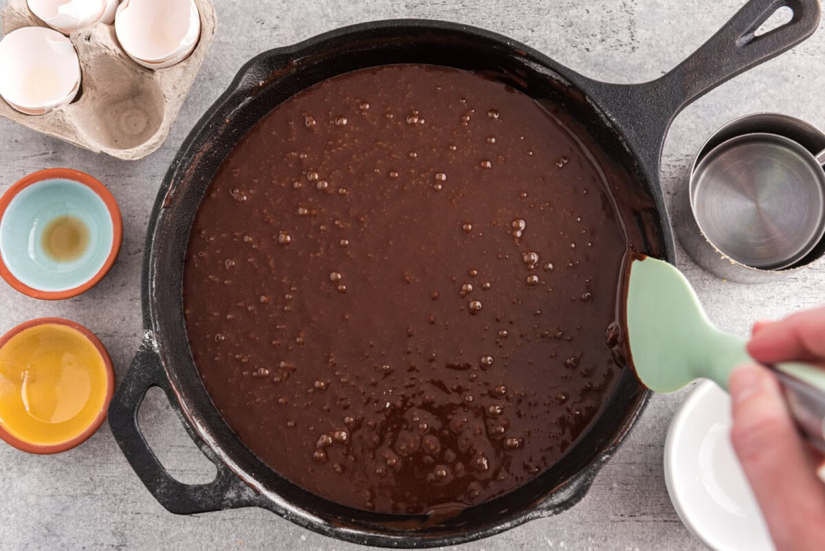 cleaning edges of brownie skillet with a rubber spatula