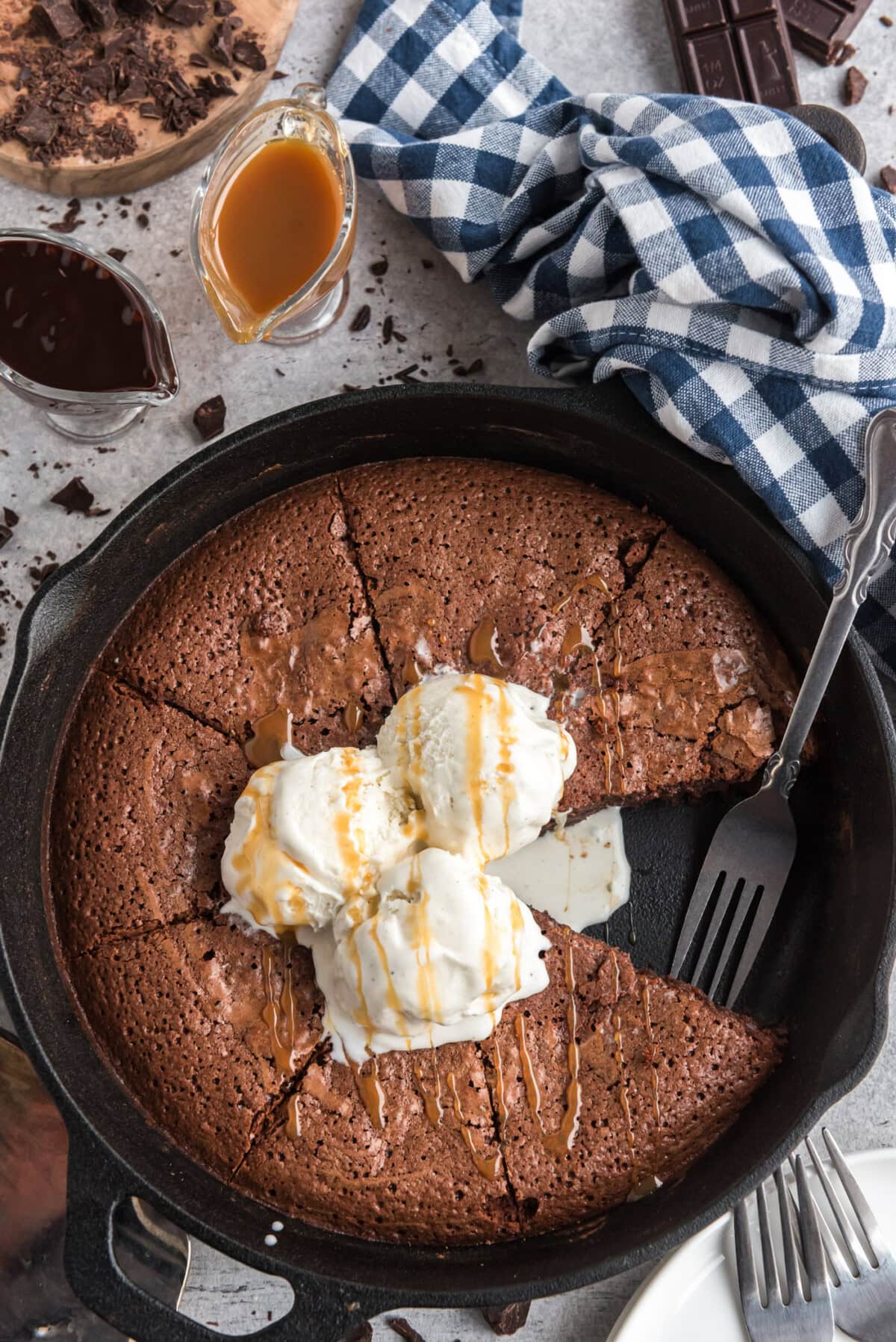 Brownies in a Cast Iron Skillet with a slice removed and a fork resting in the pan