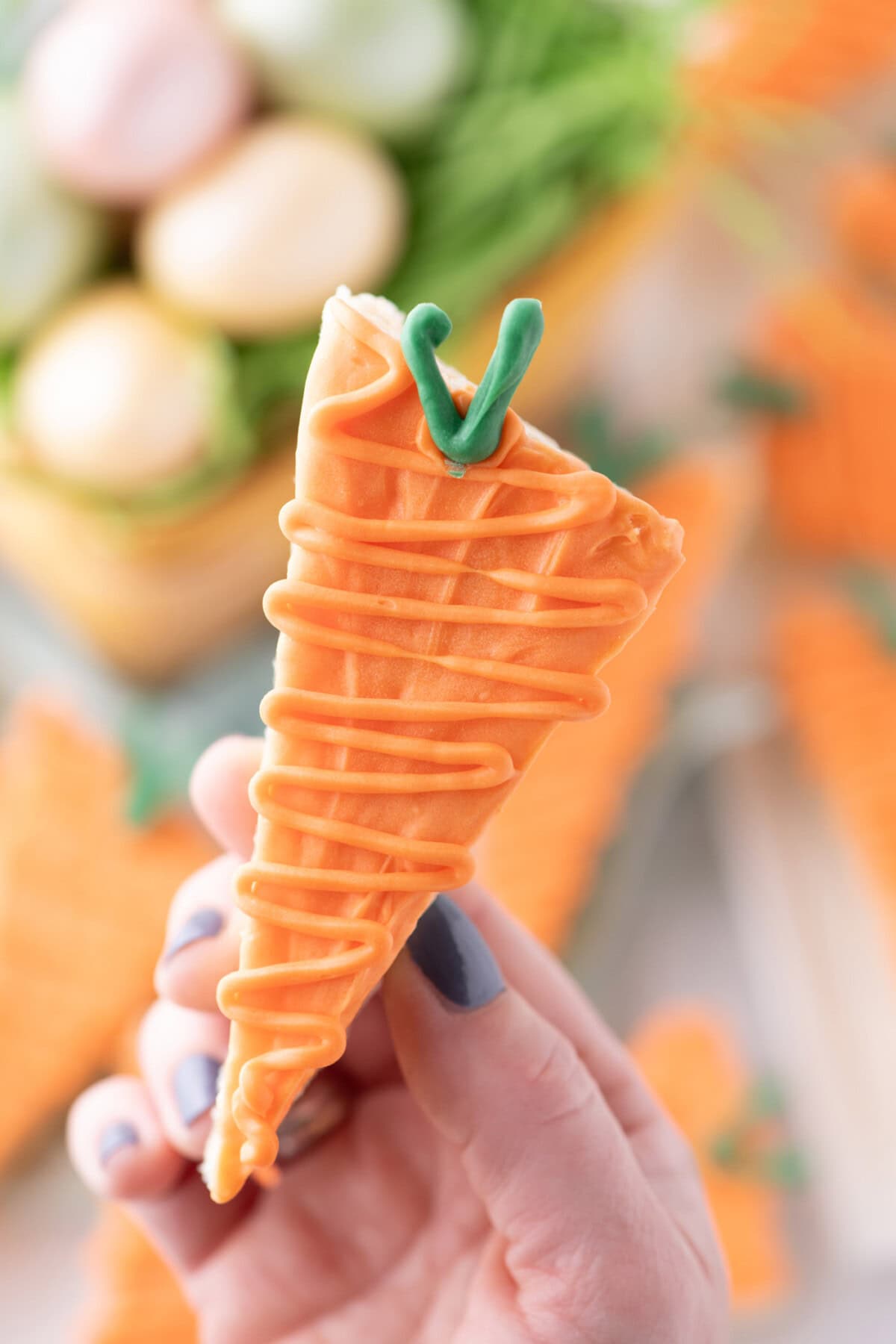 Hand holding up a Carrot Rice Krispy Treat