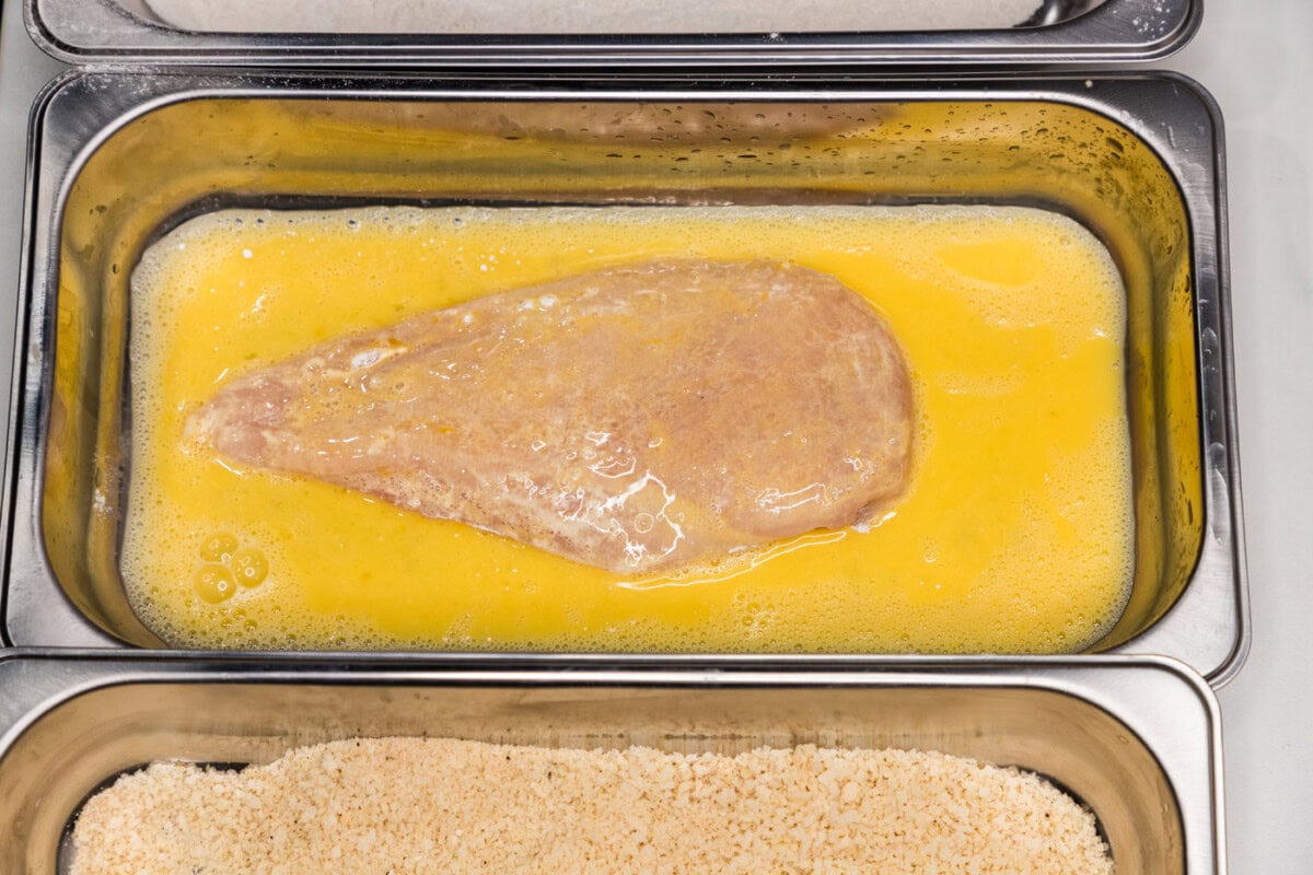 dredging chicken breast in egg