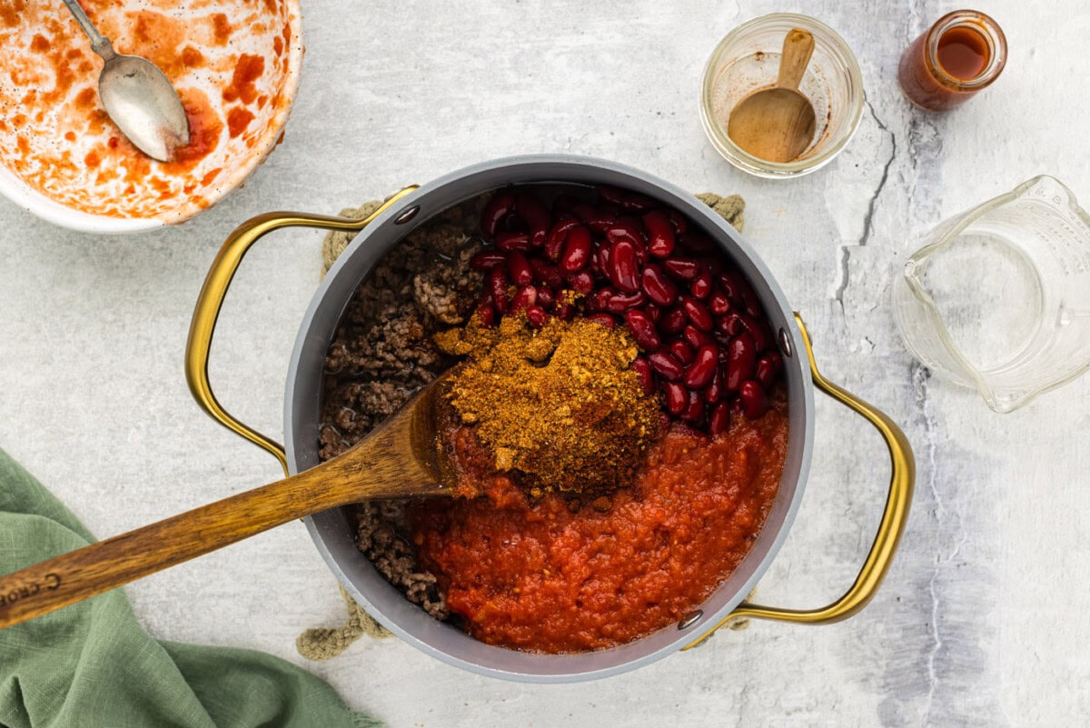 chili seasoning, tomatoes, and beans added to pot with ground beef