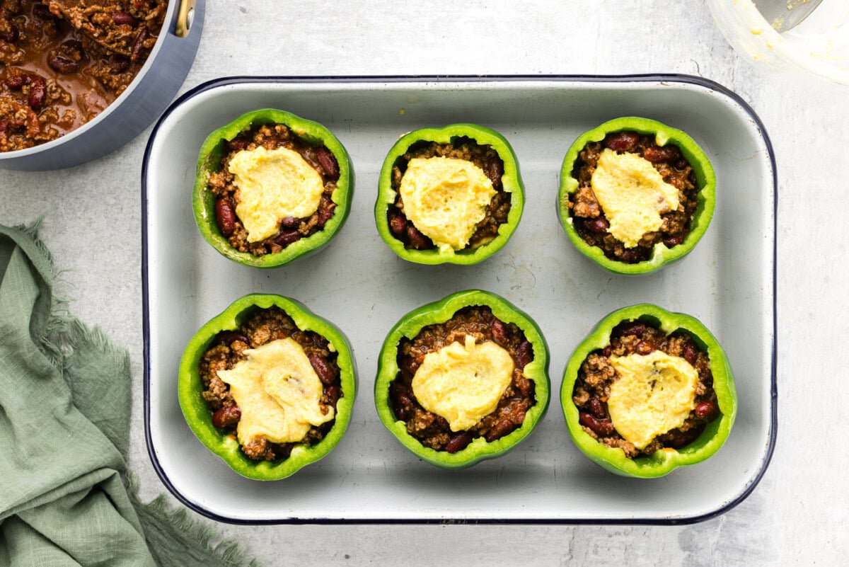 cornbread batter on top of stuffed peppers
