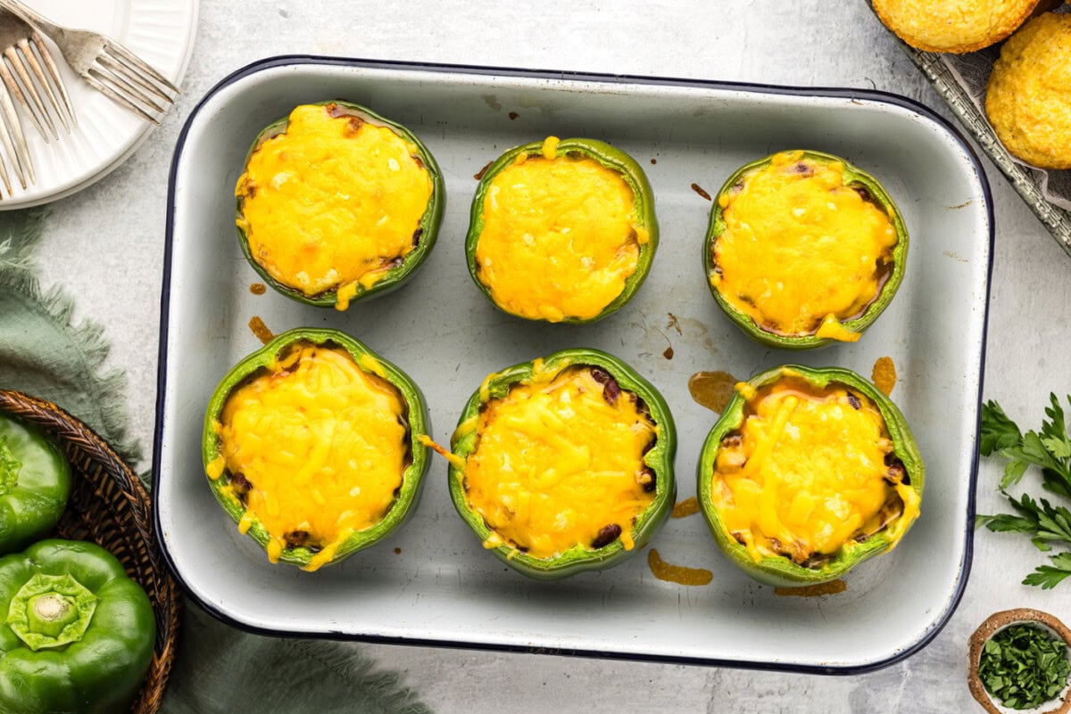 overhead of baked chili and cornbread stuffed peppers
