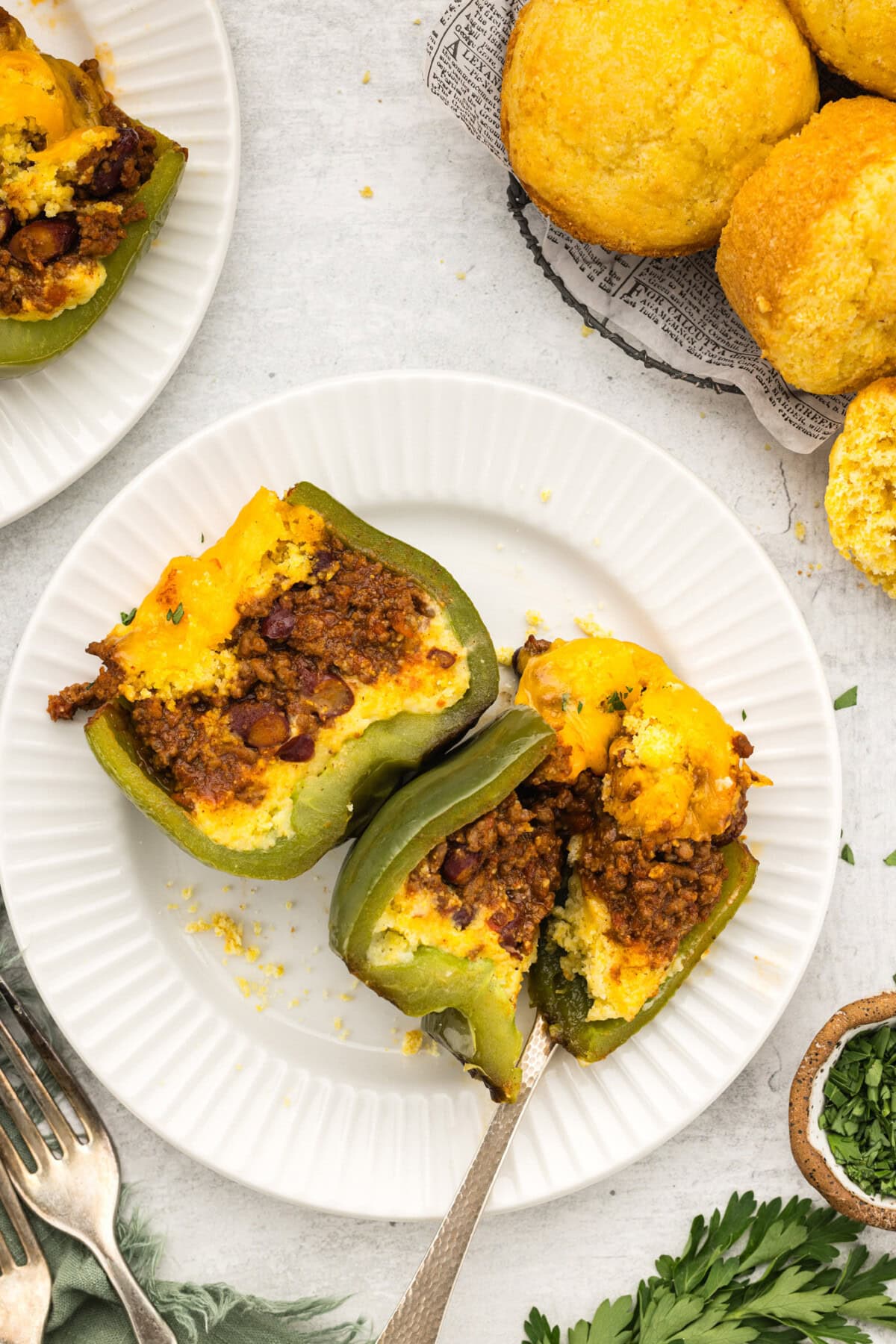 Chili and Cornbread Stuffed Pepper cut in half on a plate