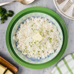 Plate of Pasta Method Rice with a butter pat on top