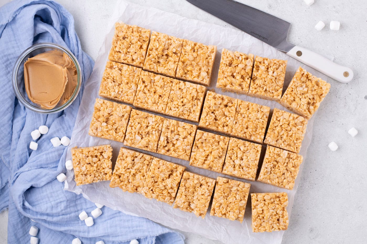 sliced peanut butter rice krispie treats on parchment paper