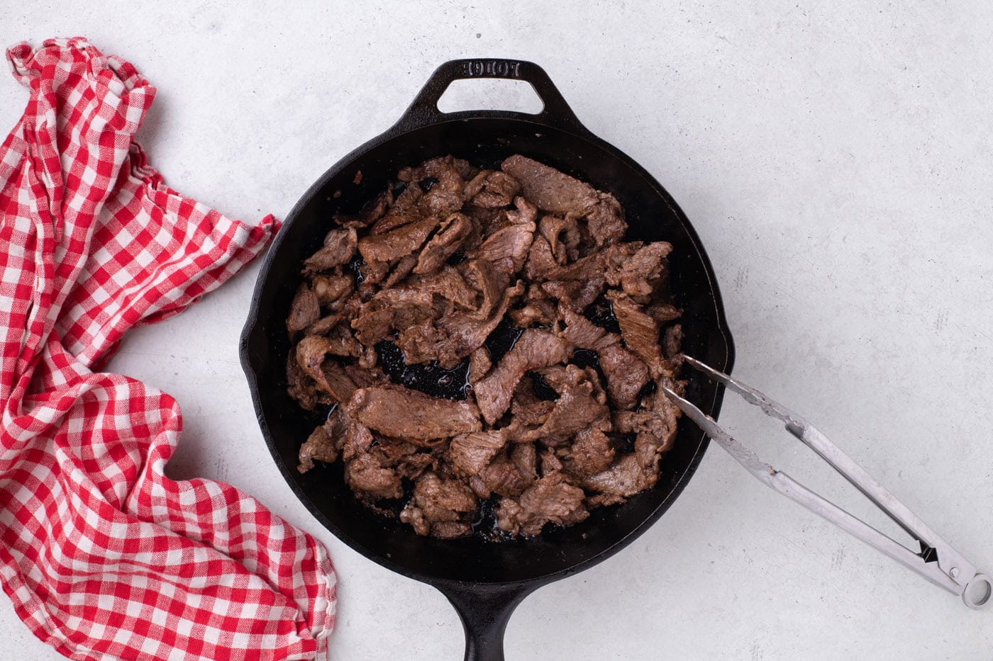 sliced ribeye steak in a skillet