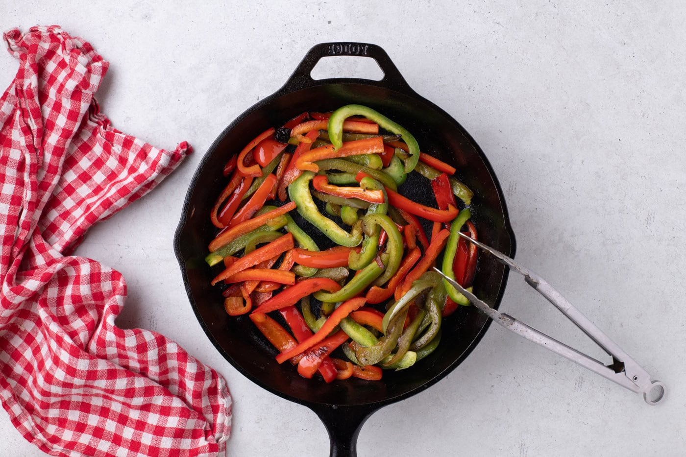 red and green bell peppers cooked in a skillet