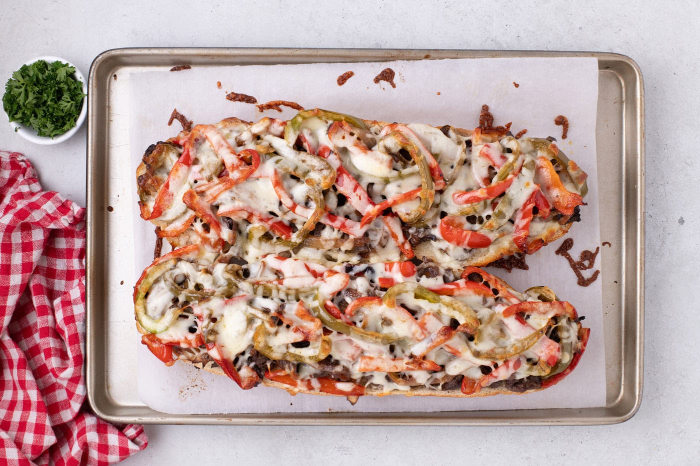 overhead of baked philly cheesesteak cheesy bread