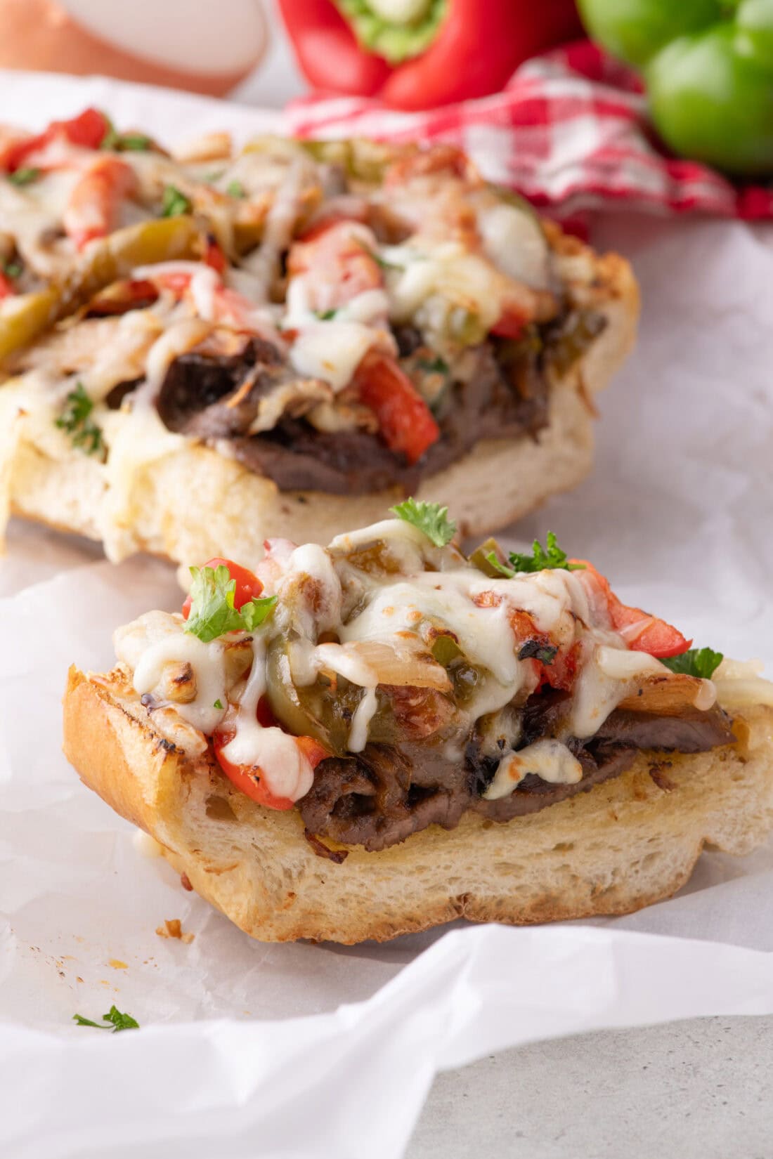 Close up photo of a slice of Philly Cheesesteak Cheesy Bread