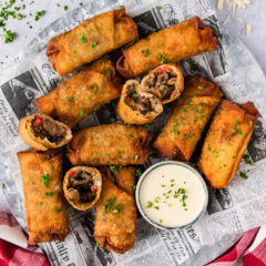 Close up photo of a platter of Philly Cheesesteak Egg Rolls