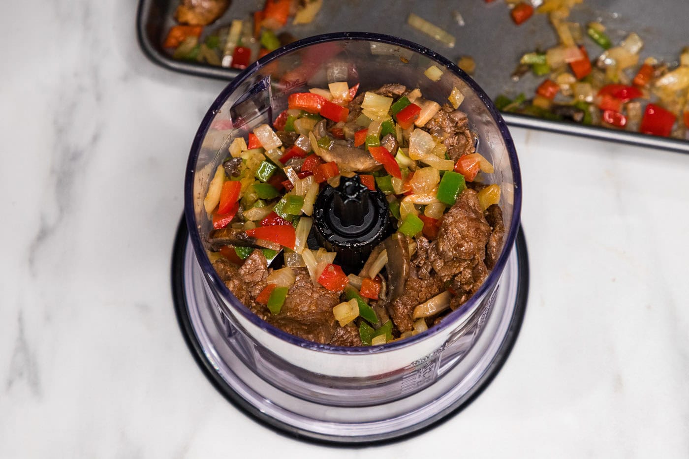 veggies and meat mixture in a food chopper