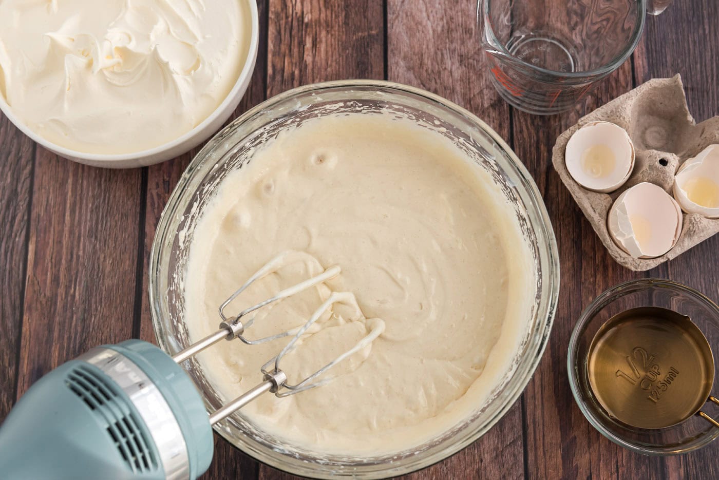 prepared cake mix batter in a bowl with a mixer