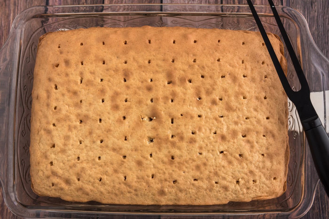 holes poked into baked cake