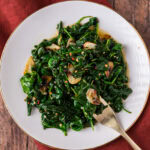 Plate of Stir Fried Spinach with a fork resting to the side