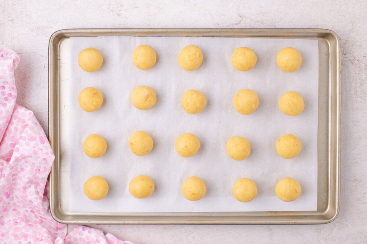 rolled cake balls on a baking sheet