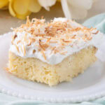Close up photo of a slice of Coconut Poke Cake