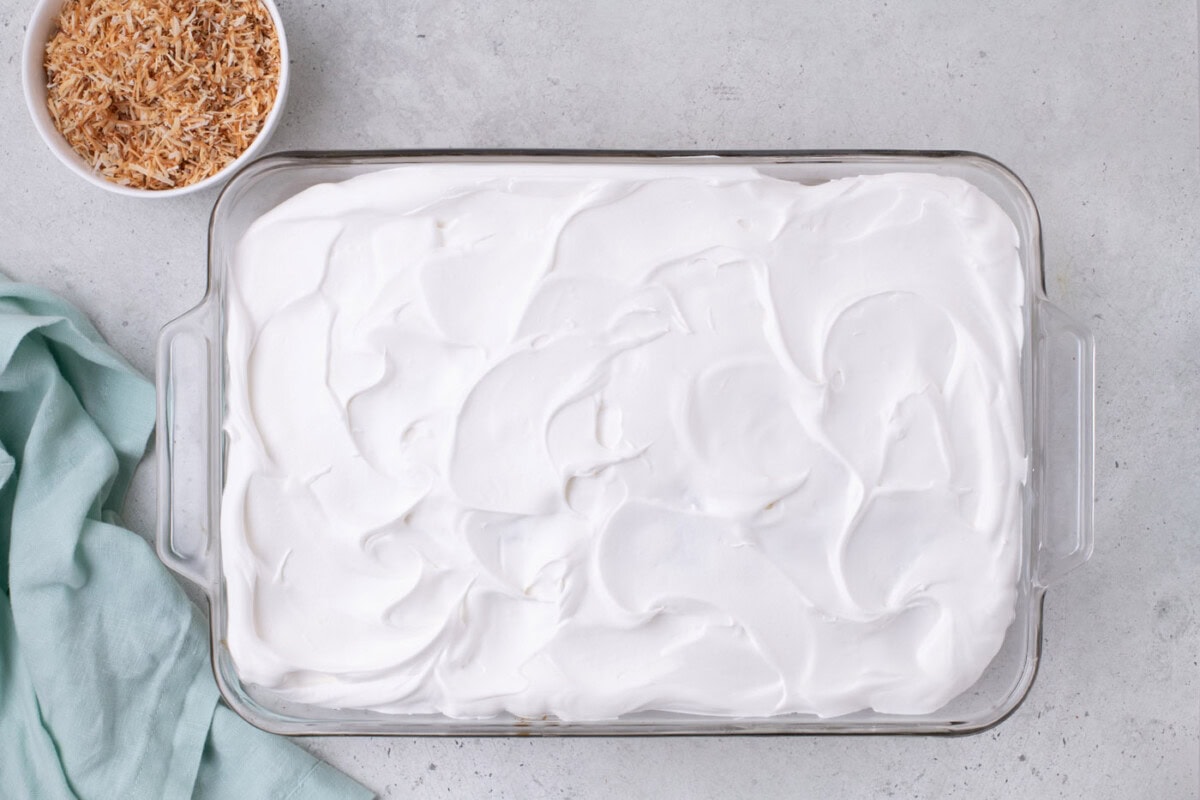 whipped topping spread over cake