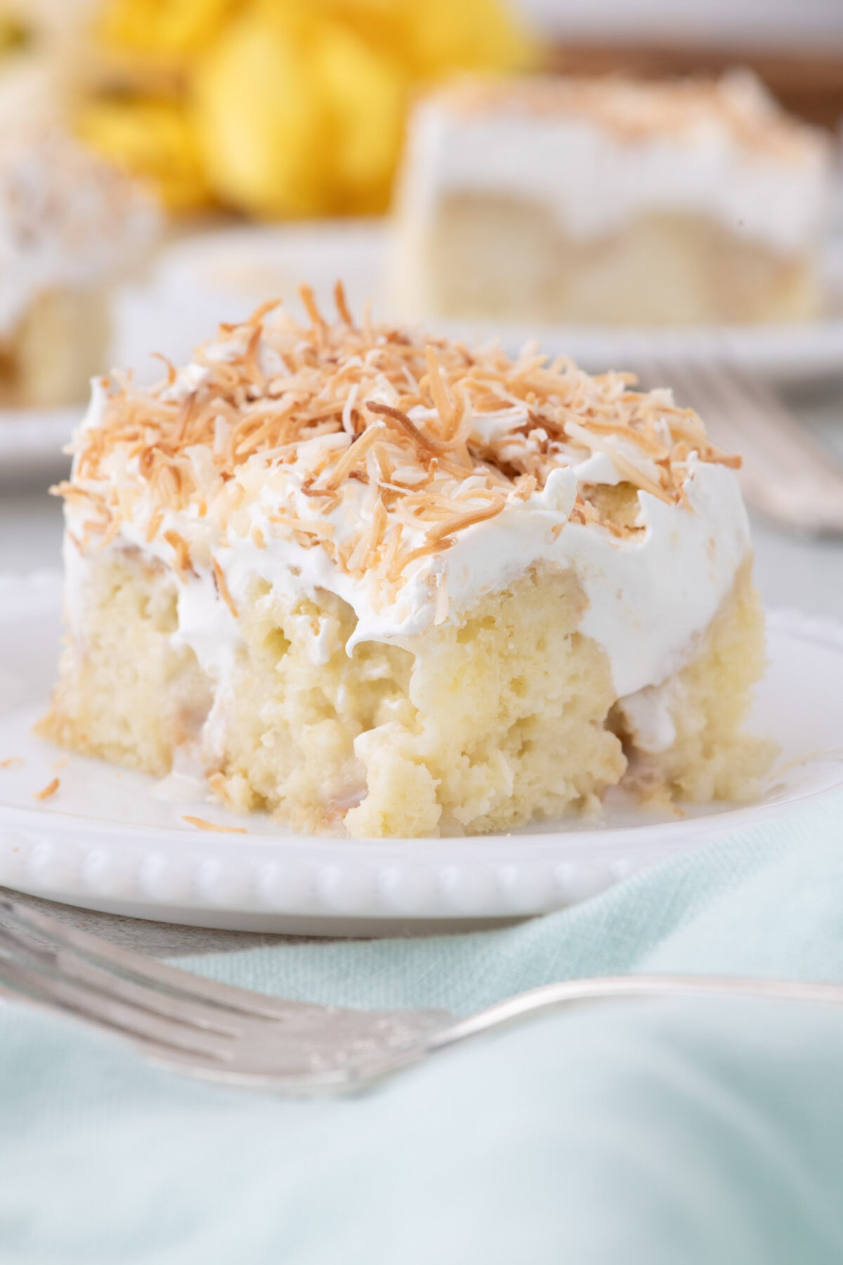 Slice of Coconut Poke Cake on a plate