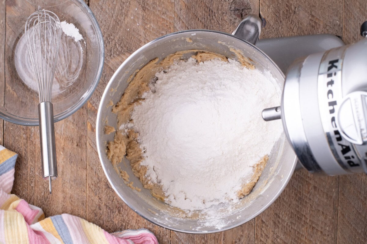 dry ingredients added to wet ingredients in a stand mixer bowl