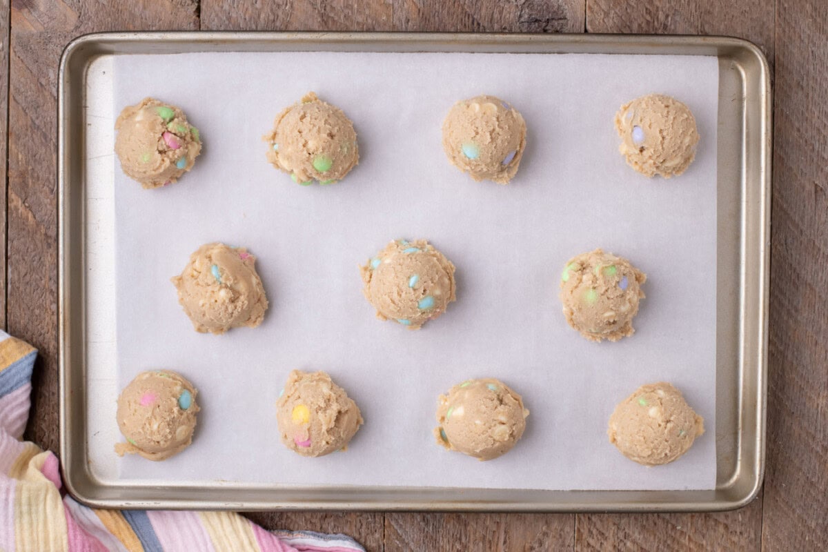 mounds of cookie dough on a baking sheet