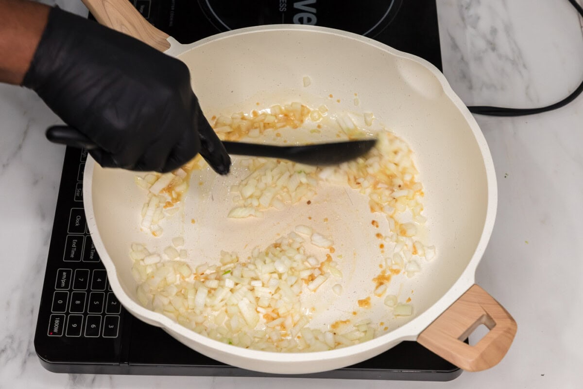 sauteeing garlic and onion in a skillet