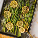Sheet pan of Lemon Asparagus with a spatula in it