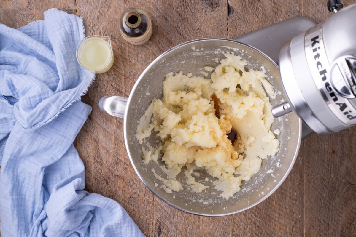 butter and sugar mixture in a stand mixer bowl with vanilla