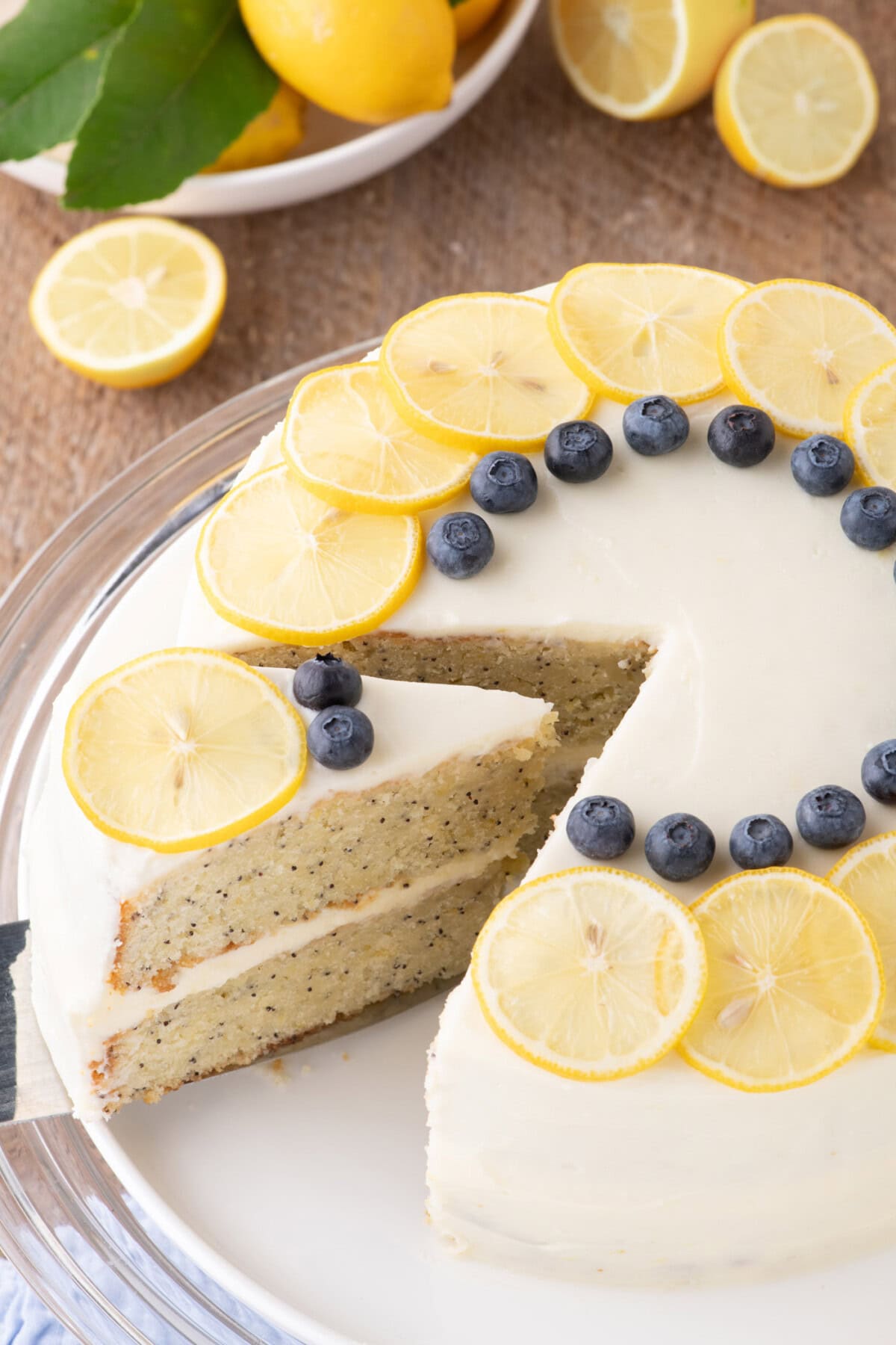Slice being removed from a Lemon Poppy Seed Cake