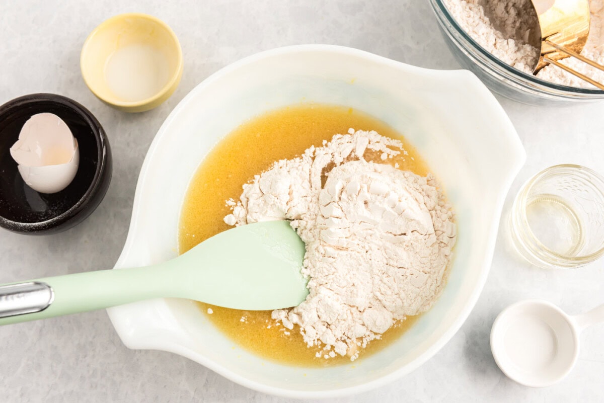 mixing flour into wet ingredients in bowl