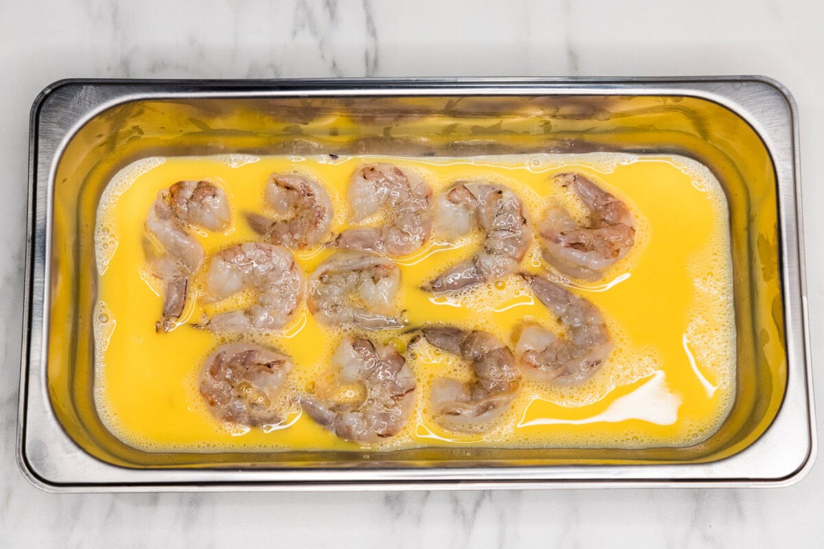 shrimp in a breading tray with egg