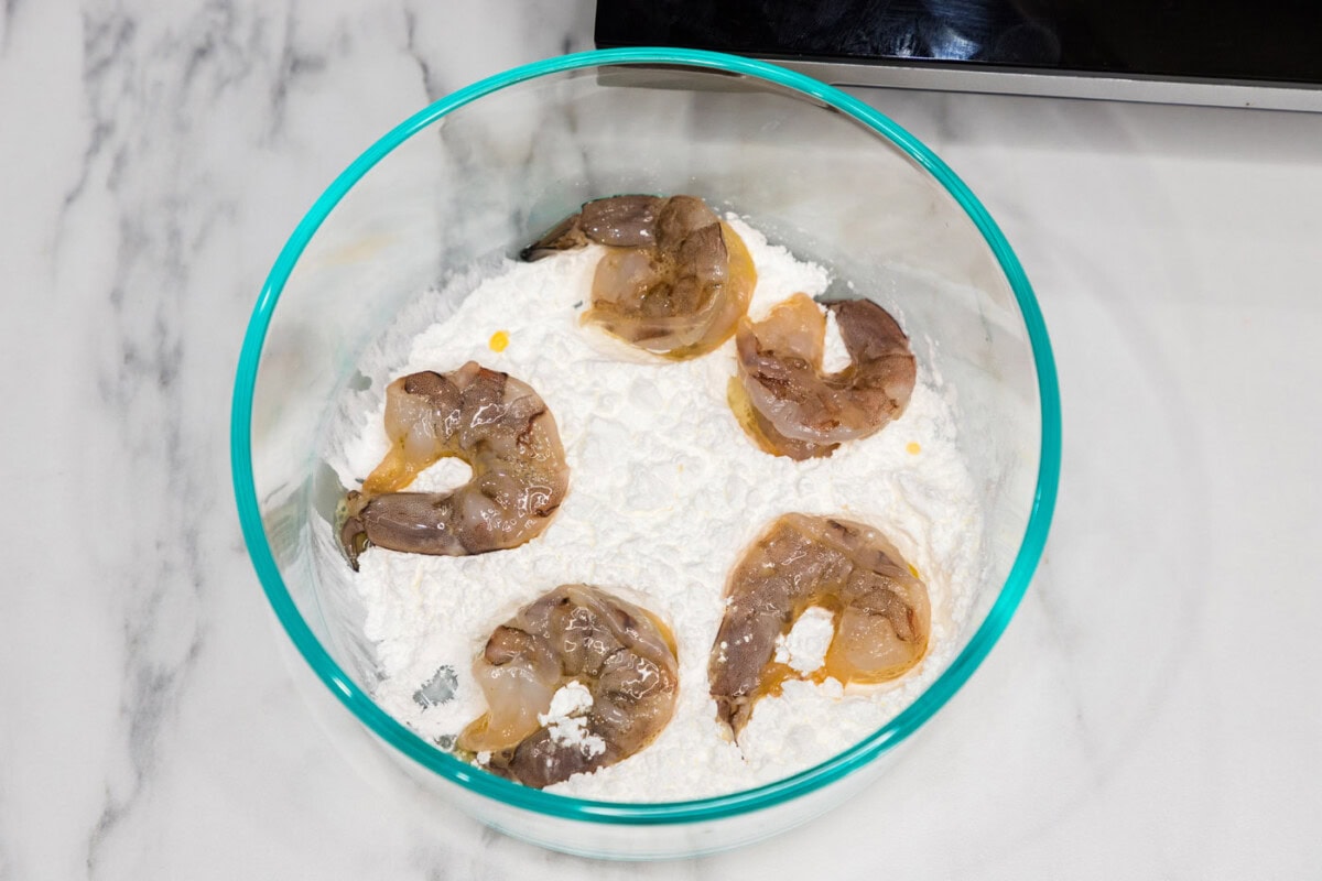 dredged shrimp in flour in a bowl