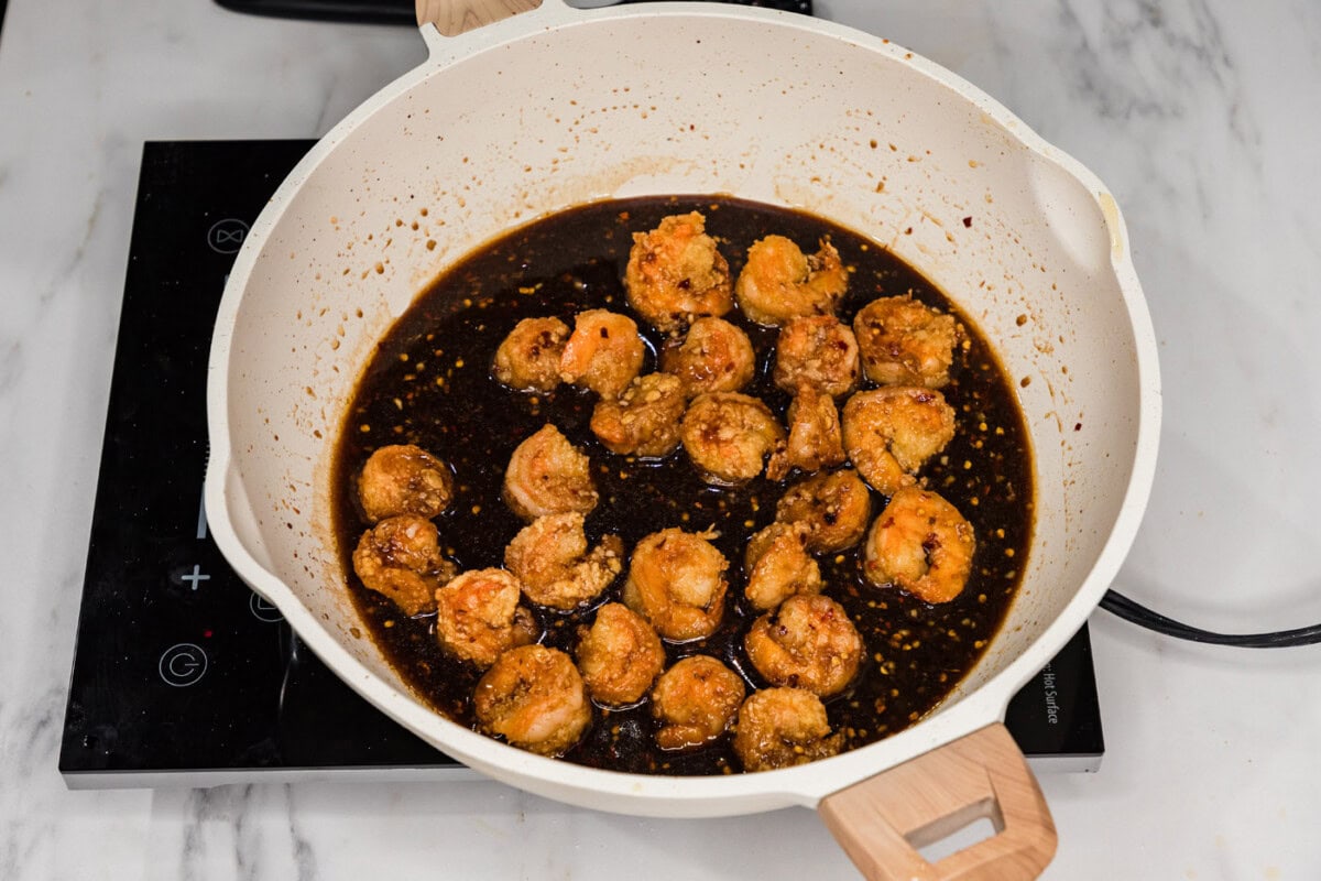 breaded shrimp in a skillet with mongolian sauce