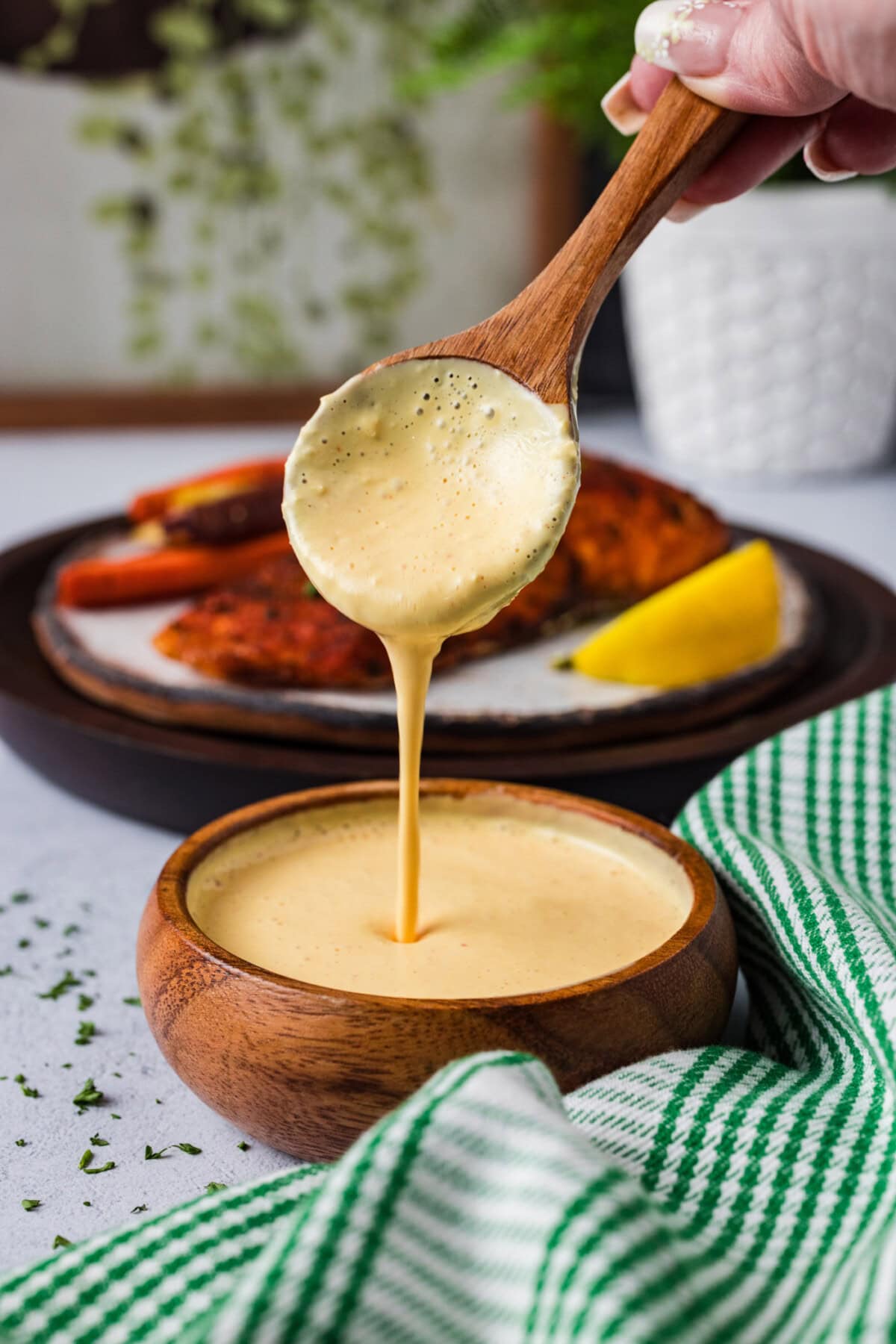 Spoon pouring Remoulade Sauce into a bowl