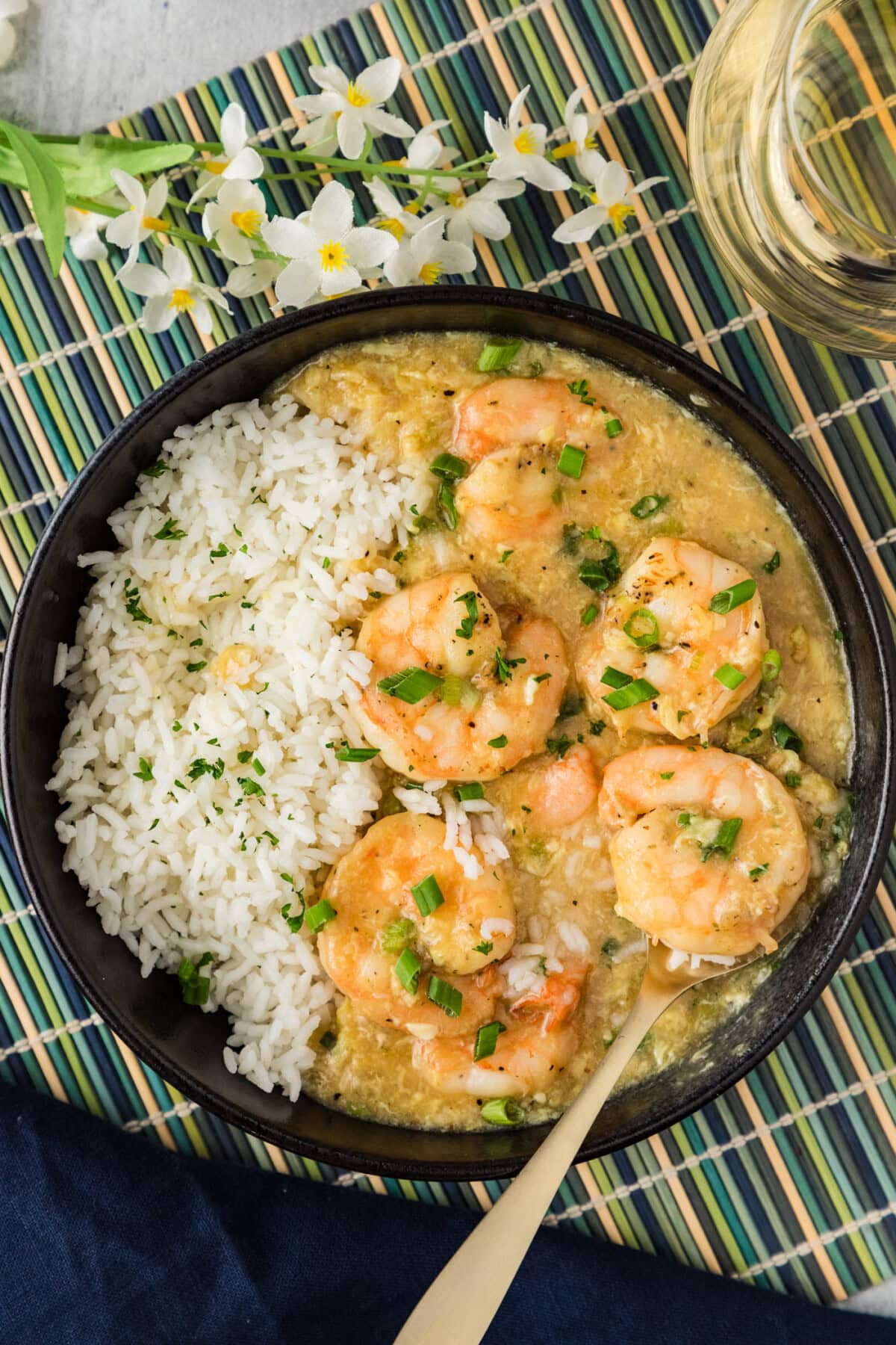 Shrimp with Lobster Sauce served in a bowl with rice and a spoon