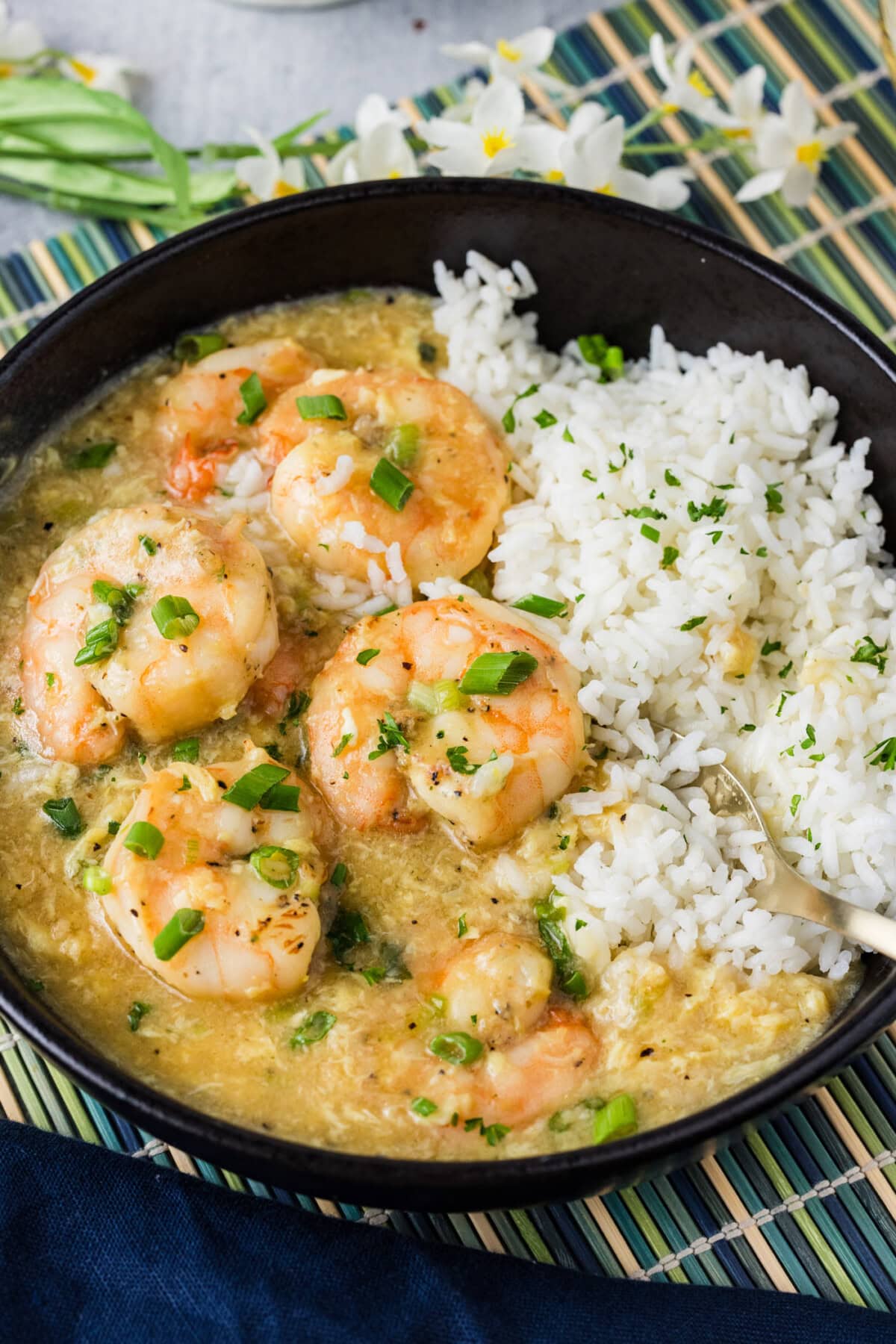 Close up photo of a bowl of rice and Shrimp with Lobster Sauce