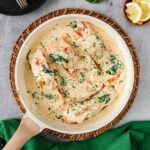 Skillet of Tuscan Salmon with lemons on the side