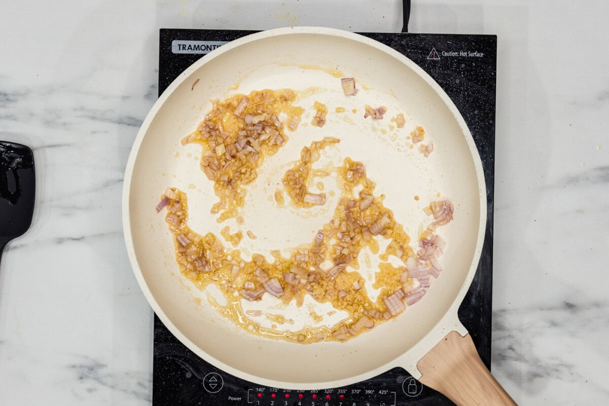 shallots and garlic sauteeing in a pan