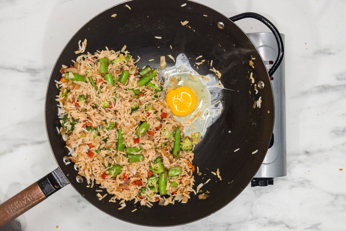 egg cooked in skillet with fried rice