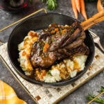 Braised Lamb Shank in a bowl served over mashed potatoes
