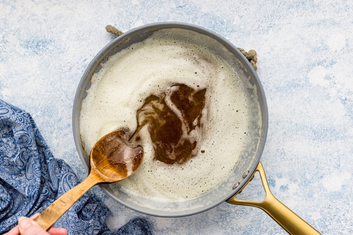 browned butter in a skillet with a wooden spoon