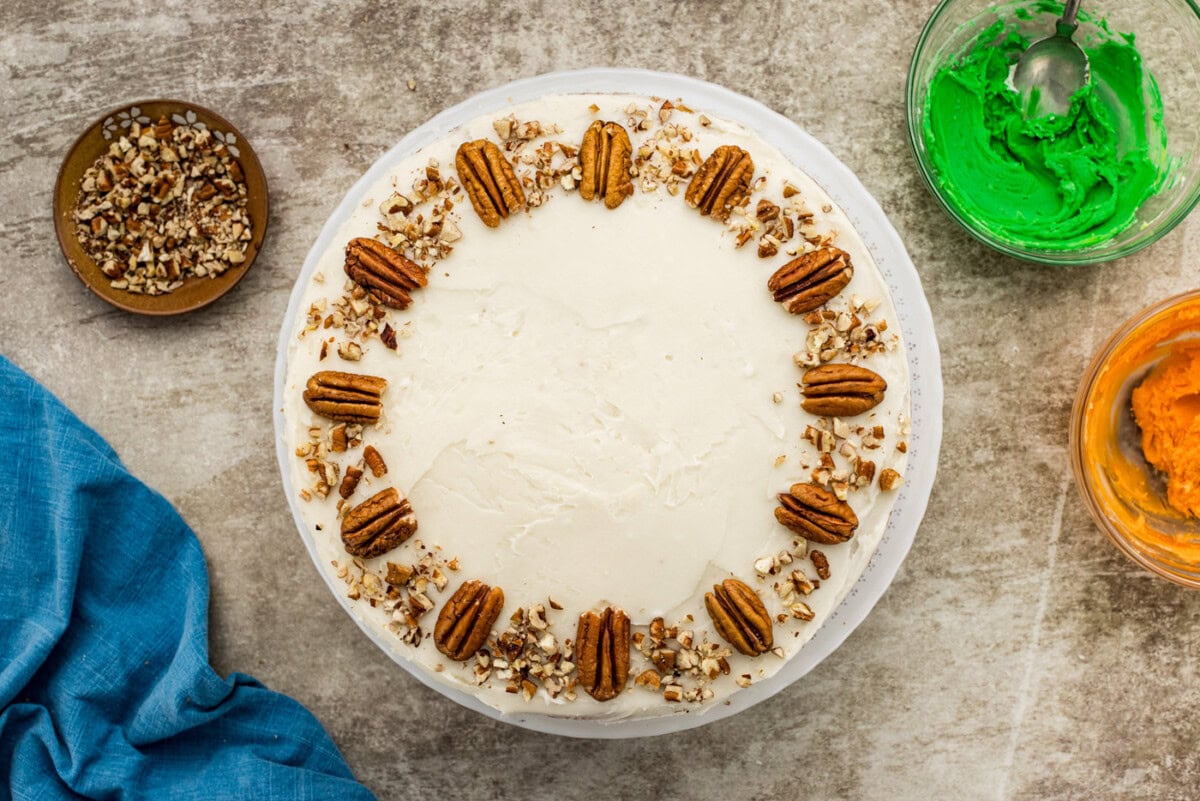 pecan halves and crushed pecans on top of carrot cake