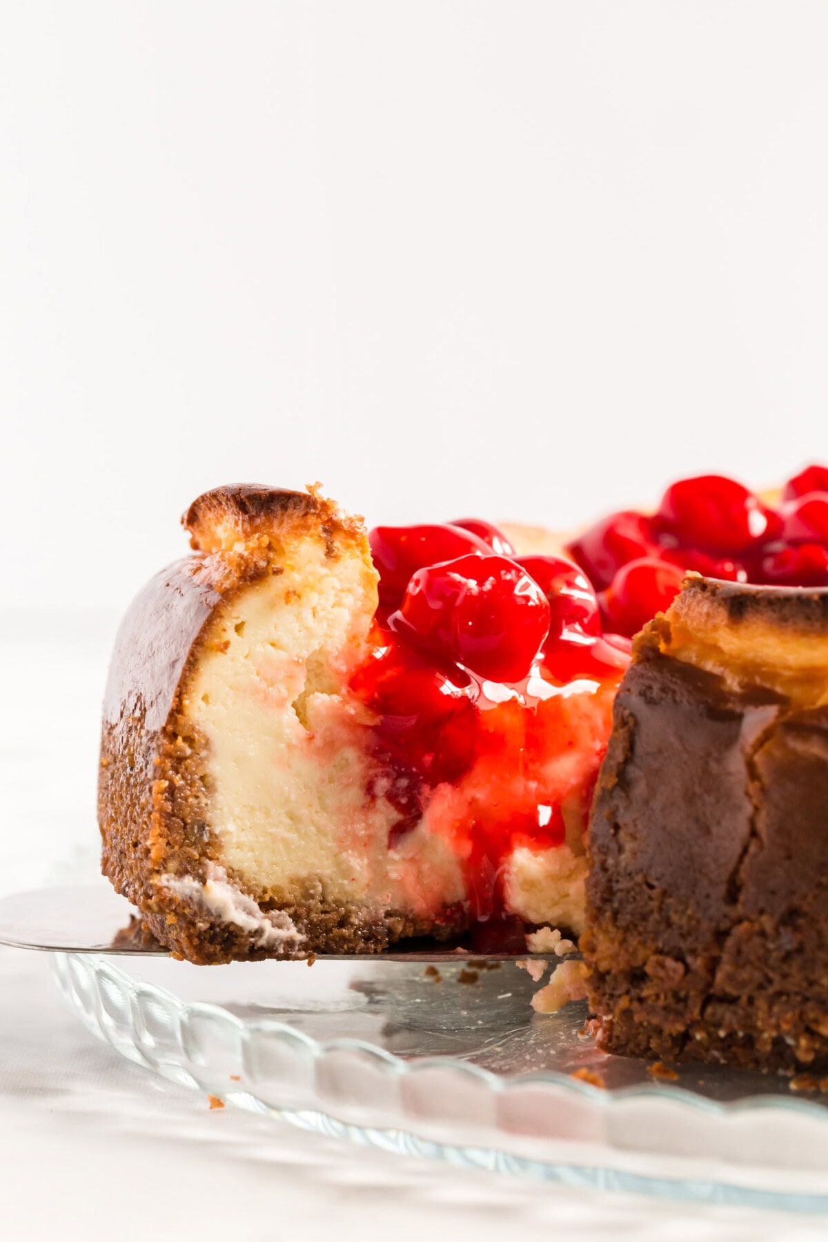Slice of Cherry Cheesecake being removed from the cheesecake